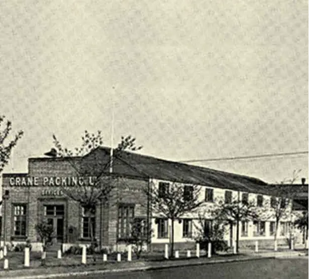 An old photo of a building with a sign on it