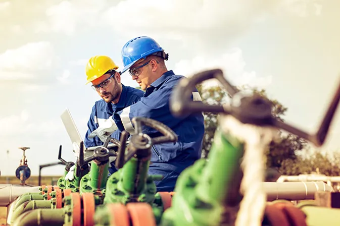 Employees On Site Using Laptop