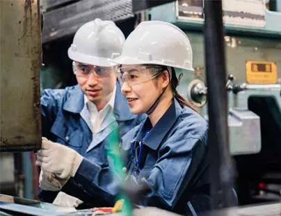 Two people working in a factory