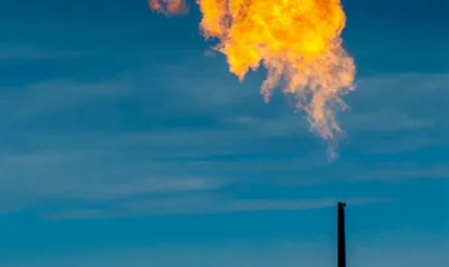 A gas flare is seen in the sky