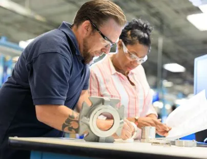 Two people working in an industrial factory