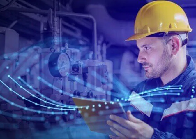A man in a hard hat holding a tablet