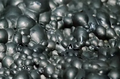 A close up of a large amount of black balls