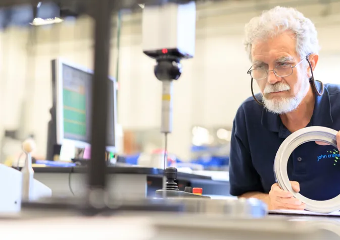 A man working on a circular object in a factory