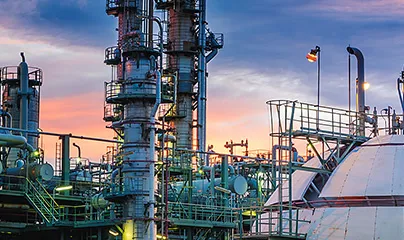 A large oil refinery at sunset