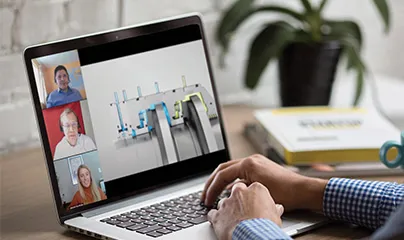 A person is using a laptop with a video call on it