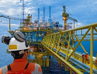 An oil rig worker looking at an offshore platform (1)