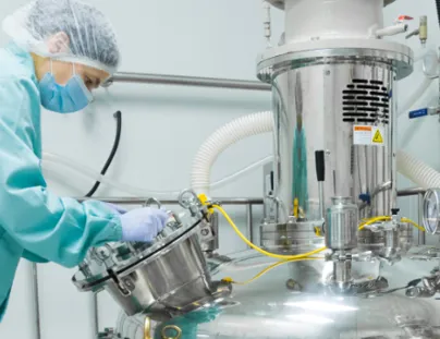 A woman in a lab coat is working on a machine
