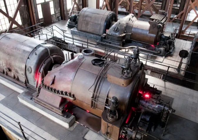 Two large steam engines in a large building