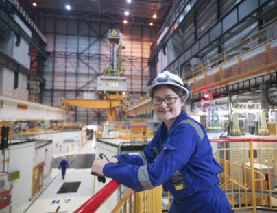 A woman in a blue uniform standing on a platform