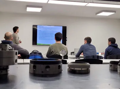A group of people in a classroom watching a presentation