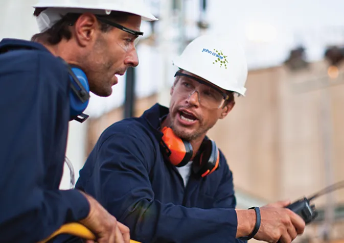 Two Men In John Crane PPE