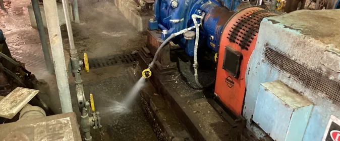 Industrial machine burst pipe with water leaking and spraying out