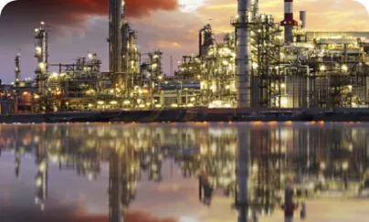 A large refinery with a large body of water