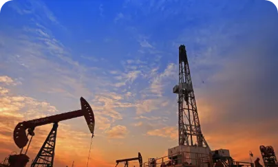Oil pumps at sunset with a blue sky